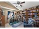 Bright bedroom featuring bookshelves, home exercise equipment, and a comfortable chair at 4002 N San Gabriel Cir, Mesa, AZ 85215