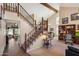 Open-concept entryway features stairs, tall ceilings with wood beams, and dining area at 4002 N San Gabriel Cir, Mesa, AZ 85215