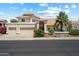 Charming two-story home featuring a tile roof, desert landscaping, and a spacious three-car garage at 4002 N San Gabriel Cir, Mesa, AZ 85215