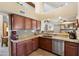 The kitchen offers granite countertops, stainless steel appliances, and convenient access to adjacent rooms at 4002 N San Gabriel Cir, Mesa, AZ 85215