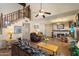 The large living room has a staircase, fireplace, and views of the backyard with light coming in from every direction at 4002 N San Gabriel Cir, Mesa, AZ 85215