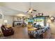 Spacious living room with a fireplace, lots of natural light, and backyard views with a large pool visible through the window at 4002 N San Gabriel Cir, Mesa, AZ 85215