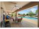 Covered patio features ceiling fans and overlooks the sparkling pool and backyard at 4002 N San Gabriel Cir, Mesa, AZ 85215