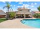 The covered patio overlooks the large swimming pool and well manicured lawn at 4002 N San Gabriel Cir, Mesa, AZ 85215