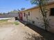 Back yard view, showing the exterior of the home and an access door at 4110 E Wagoner Rd, Phoenix, AZ 85032