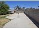 Exterior view of backyard with concrete slab, vintage trailer and metal structure at 4110 E Wagoner Rd, Phoenix, AZ 85032