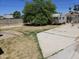Exterior view of backyard with concrete slab, vintage trailer and mature tree at 4110 E Wagoner Rd, Phoenix, AZ 85032