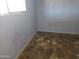This is a rundown bedroom with dirty walls, dirty flooring, and a light fixture at 4110 E Wagoner Rd, Phoenix, AZ 85032