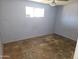 This is a rundown bedroom with dirty walls and old flooring at 4110 E Wagoner Rd, Phoenix, AZ 85032