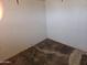 This is an empty bedroom with white walls and bad flooring at 4110 E Wagoner Rd, Phoenix, AZ 85032