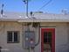 Exterior view of home with red door, window and utility box at 4110 E Wagoner Rd, Phoenix, AZ 85032
