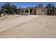 Charming single-story home featuring desert landscaping and a long driveway with a pop of color from a red front door at 4110 E Wagoner Rd, Phoenix, AZ 85032