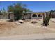 Desert landscaped front yard featuring native plants, stones, and a unique pathway at 4110 E Wagoner Rd, Phoenix, AZ 85032