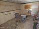 The garage space, needs flooring, featuring open storage, tools, and utility items for the handy homeowner at 4110 E Wagoner Rd, Phoenix, AZ 85032