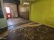 Needs flooring, a bright living room features a large window and red door, ready for renovation at 4110 E Wagoner Rd, Phoenix, AZ 85032