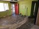 Unfinished living room featuring bright green walls, a ceiling fan, and an open doorway at 4110 E Wagoner Rd, Phoenix, AZ 85032