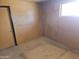 Empty room with a window, tan walls and a door at 4110 E Wagoner Rd, Phoenix, AZ 85032