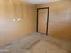 Empty room with dirty walls, damaged floors, and dark trim at 4110 E Wagoner Rd, Phoenix, AZ 85032