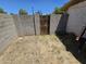 Exterior shot of a small yard with a concrete block wall and iron gate at 4110 E Wagoner Rd, Phoenix, AZ 85032