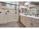 Modern bathroom featuring double sinks, a glass shower, and a well-lit, updated design at 41215 W Almira Dr, Maricopa, AZ 85138