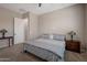 Relaxing bedroom with gray bedding, complementing nightstands, and lamps providing a cozy, serene atmosphere at 41215 W Almira Dr, Maricopa, AZ 85138