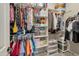 Organized walk-in closet with ample hanging space, shelves, and various storage containers for optimal organization at 41215 W Almira Dr, Maricopa, AZ 85138