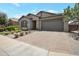 Beautiful home featuring a stone facade, paved driveway, and drought-resistant landscaping at 41215 W Almira Dr, Maricopa, AZ 85138