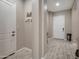 Inviting foyer with tile floors, white doors, and a charming key and mail holder at 41215 W Almira Dr, Maricopa, AZ 85138