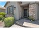 Home featuring a stone pillar entrance with a black front door and manicured landscaping at 41215 W Almira Dr, Maricopa, AZ 85138