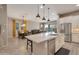 Open concept kitchen with an island, stainless steel appliances, and an adjacent dining area at 41215 W Almira Dr, Maricopa, AZ 85138