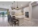 Bright, modern kitchen featuring an island with bar seating, stainless steel appliances, and ample cabinets at 41215 W Almira Dr, Maricopa, AZ 85138