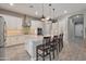 Modern kitchen featuring a large island with barstool seating and stainless steel appliances at 41215 W Almira Dr, Maricopa, AZ 85138