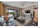 Open living room featuring sliding glass doors to the backyard and a leather sofa set at 41215 W Almira Dr, Maricopa, AZ 85138