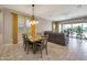 Open floorplan boasts dining area, recessed lighting, and sliding glass doors with backyard views at 41215 W Almira Dr, Maricopa, AZ 85138
