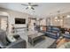 Spacious open floorplan boasts an eat-in kitchen, living area with sofa set, and dining area at 41215 W Almira Dr, Maricopa, AZ 85138