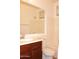 Bright bathroom featuring a single sink vanity, a large mirror, and a shower-tub combo at 4145 E Santa Fe Ln, Gilbert, AZ 85297