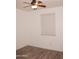 Bedroom with wood-look floors, ceiling fan, and bright natural light from a large window at 4145 E Santa Fe Ln, Gilbert, AZ 85297