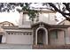 Charming two-story home featuring a stone-accented entrance and a well-maintained front yard at 4145 E Santa Fe Ln, Gilbert, AZ 85297