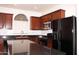 Kitchen features granite countertops, stainless steel appliances, and a center island with bar seating at 4145 E Santa Fe Ln, Gilbert, AZ 85297