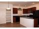 Kitchen features granite countertops, stainless steel appliances, and a center island with bar seating at 4145 E Santa Fe Ln, Gilbert, AZ 85297