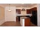 Kitchen features granite countertops, stainless steel appliances, and a center island with bar seating at 4145 E Santa Fe Ln, Gilbert, AZ 85297