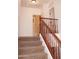 Carpeted staircase with wooden railing leading to the bedrooms upstairs at 4145 E Santa Fe Ln, Gilbert, AZ 85297