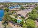 This aerial view showcases an elegant home with a manicured yard, pool, outdoor patio, and beautiful lake views at 422 E Kaibab Pl, Chandler, AZ 85249