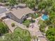 This aerial view features a large home with mature landscaping, a pool, patio, and a putting green at 422 E Kaibab Pl, Chandler, AZ 85249
