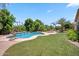 This expansive backyard features a refreshing pool, manicured lawn, and mature landscaping, ideal for outdoor living at 422 E Kaibab Pl, Chandler, AZ 85249