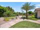 The serene backyard with a decorative stone walkway is complemented with green spaces and desert landscaping at 422 E Kaibab Pl, Chandler, AZ 85249