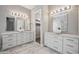 Elegant bathroom featuring double sinks, marble countertops, and a view into a walk in closet at 422 E Kaibab Pl, Chandler, AZ 85249