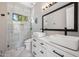 Updated bathroom with dual sinks, framed mirror, and frameless glass shower door at 422 E Kaibab Pl, Chandler, AZ 85249