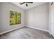 Bright bedroom with a large window and wood-look tile floor at 422 E Kaibab Pl, Chandler, AZ 85249