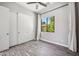 Bright bedroom with a large window, wood-look floors, and a closet with sliding doors at 422 E Kaibab Pl, Chandler, AZ 85249